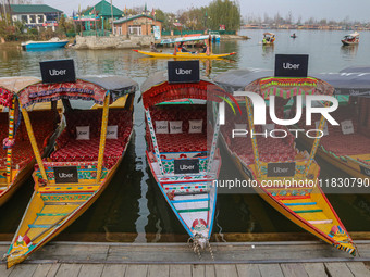 Uber signs are displayed on ''Shikaras'' or small boats after Uber launches its first water transport service on the waters of Dal Lake, in...