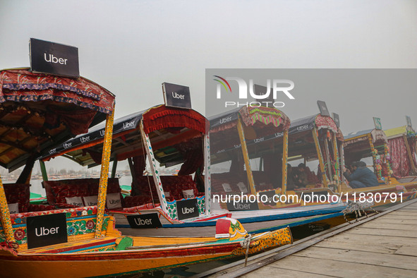 Uber signs are displayed on ''Shikaras'' or small boats after Uber launches its first water transport service on the waters of Dal Lake, in...