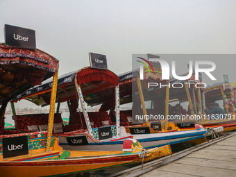 Uber signs are displayed on ''Shikaras'' or small boats after Uber launches its first water transport service on the waters of Dal Lake, in...