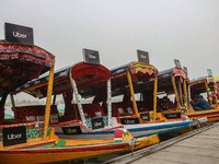 Uber signs are displayed on ''Shikaras'' or small boats after Uber launches its first water transport service on the waters of Dal Lake, in...