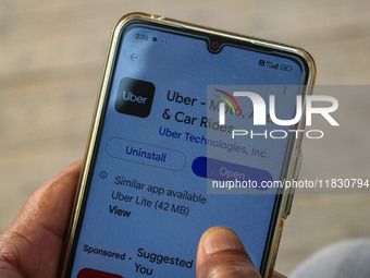 A man downloads the Uber app after Uber launches its first water transport service on the waters of Dal Lake, in Srinagar, Jammu and Kashmir...