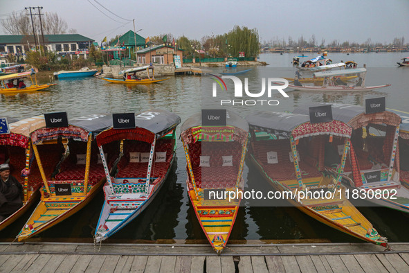 Uber signs are displayed on ''Shikaras'' or small boats after Uber launches its first water transport service on the waters of Dal Lake, in...