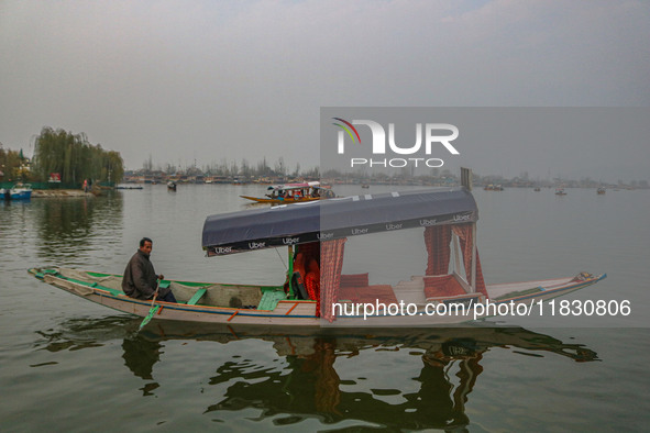 Abdul Rashid Bhat, 55, an Uber boat owner, rows his Shikara after Uber launches its first water transport service on the waters of Dal Lake,...