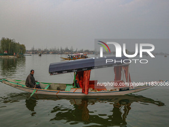 Abdul Rashid Bhat, 55, an Uber boat owner, rows his Shikara after Uber launches its first water transport service on the waters of Dal Lake,...