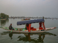 Abdul Rashid Bhat, 55, an Uber boat owner, rows his Shikara after Uber launches its first water transport service on the waters of Dal Lake,...