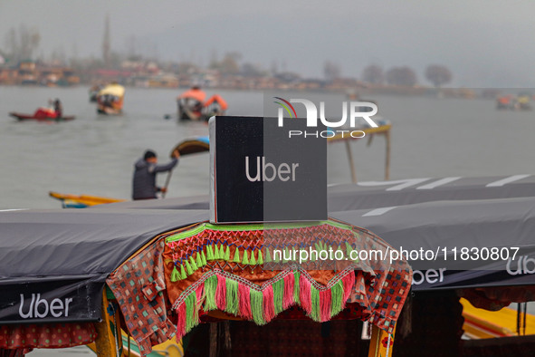 Uber signs are displayed on a ''Shikara'' or small boat after Uber launches its first water transport service on the waters of Dal Lake, in...