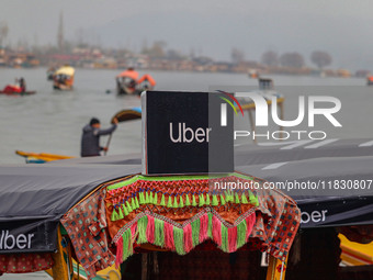 Uber signs are displayed on a ''Shikara'' or small boat after Uber launches its first water transport service on the waters of Dal Lake, in...