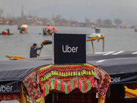 Uber signs are displayed on a ''Shikara'' or small boat after Uber launches its first water transport service on the waters of Dal Lake, in...