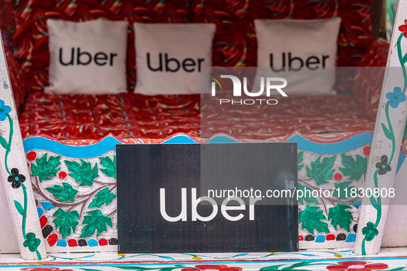 Uber signs are displayed on ''Shikaras'' or small boats after Uber launches its first water transport service on the waters of Dal Lake, in...