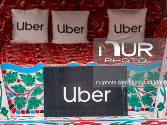 Uber signs are displayed on ''Shikaras'' or small boats after Uber launches its first water transport service on the waters of Dal Lake, in...