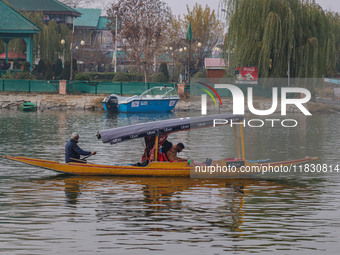 Indian tourists take the Uber ''Shikara'' or small boat ride after Uber launches its first water transport service on the waters of Dal Lake...