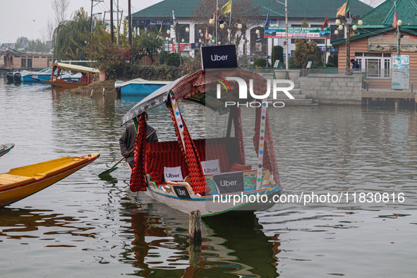 Abdul Rashid Bhat, 55, an Uber boat owner, rows his Shikara after Uber launches its first water transport service on the waters of Dal Lake,...