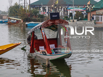 Abdul Rashid Bhat, 55, an Uber boat owner, rows his Shikara after Uber launches its first water transport service on the waters of Dal Lake,...