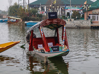 Abdul Rashid Bhat, 55, an Uber boat owner, rows his Shikara after Uber launches its first water transport service on the waters of Dal Lake,...