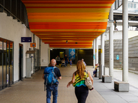 Passengers check departures at Ludwigsburg Station in Germany on July 1, 2023. Travelers of all ages pass beneath the digital timetable disp...