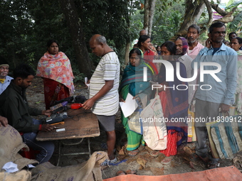 People receive rations under the ''Duare Ration'' (Ration at the doorstep) scheme at a temporary camp in Jayanagar village on the outskirts...