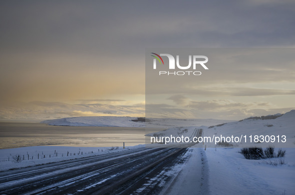 The alternate road 82, along the coast on the way to the town of Hjalteyri, Iceland, on November 27, 2024, presents unique challenges due to...