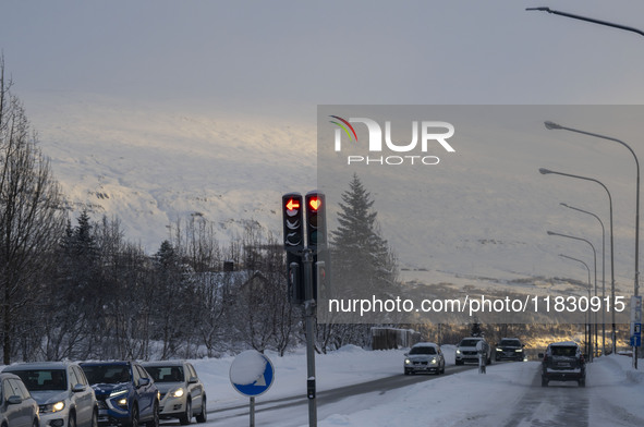 A traffic light is at an intersection on route number 1 (Ring Road) near the city of Akureyri, Iceland, on November 27, 2024. Roads in north...