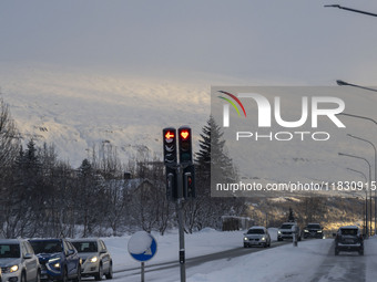 A traffic light is at an intersection on route number 1 (Ring Road) near the city of Akureyri, Iceland, on November 27, 2024. Roads in north...