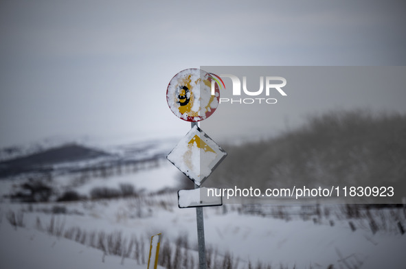 A traffic sign is partially covered by snow on Route 1 (Ring Road) on the way to the town of Blonduos in Iceland on November 27, 2024. Roads...