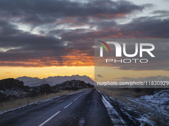 Sunset occurs on the alternate road 555 in the region of Kleppjarnsreykir, Iceland, on November 27, 2024. Roads in northern Iceland present...