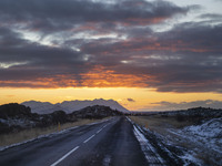 Sunset occurs on the alternate road 555 in the region of Kleppjarnsreykir, Iceland, on November 27, 2024. Roads in northern Iceland present...