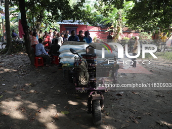 People receive rations under the ''Duare Ration'' (Ration at the doorstep) scheme at a temporary camp in Jayanagar village on the outskirts...