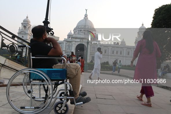 A physically challenged boy on a handicapped tricycle looks at Victoria Memorial during World Disability Day in Kolkata, India, on December...