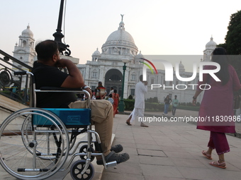 A physically challenged boy on a handicapped tricycle looks at Victoria Memorial during World Disability Day in Kolkata, India, on December...