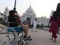 A physically challenged boy on a handicapped tricycle looks at Victoria Memorial during World Disability Day in Kolkata, India, on December...