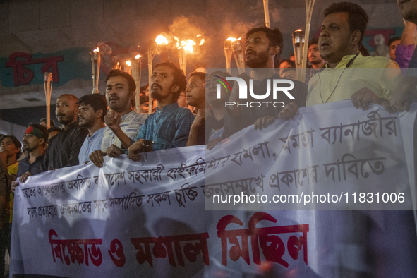 Protesters hold a torchlight procession on the Dhaka University campus in Dhaka, Bangladesh, on December 3, 2024. The demonstration protests...