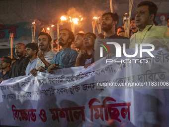 Protesters hold a torchlight procession on the Dhaka University campus in Dhaka, Bangladesh, on December 3, 2024. The demonstration protests...