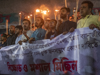 Protesters hold a torchlight procession on the Dhaka University campus in Dhaka, Bangladesh, on December 3, 2024. The demonstration protests...