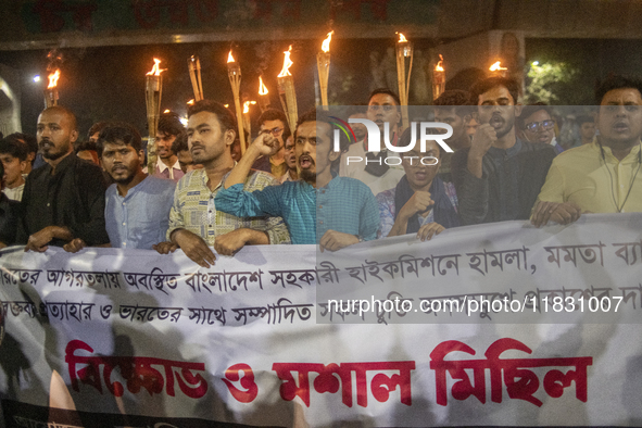 Protesters hold a torchlight procession on the Dhaka University campus in Dhaka, Bangladesh, on December 3, 2024. The demonstration protests...