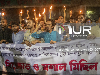 Protesters hold a torchlight procession on the Dhaka University campus in Dhaka, Bangladesh, on December 3, 2024. The demonstration protests...