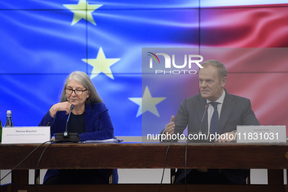 Polish Prime Minister Donald Tusk and Secretary-General of the Council of the European Union Therese Blanchet participate in a meeting with...