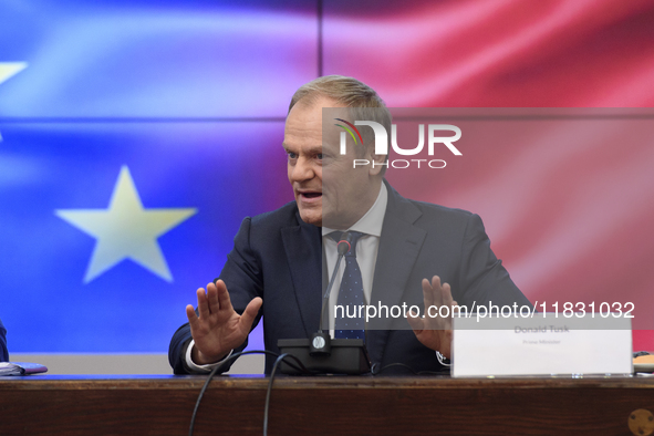 Polish Prime Minister Donald Tusk gestures as he speaks during a meeting with the Secretary-General of the Council of the European Union (EU...