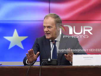 Polish Prime Minister Donald Tusk gestures as he speaks during a meeting with the Secretary-General of the Council of the European Union (EU...