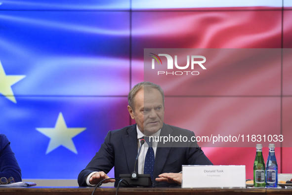 Polish Prime Minister Donald Tusk gestures as he speaks during a meeting with the Secretary-General of the Council of the European Union (EU...