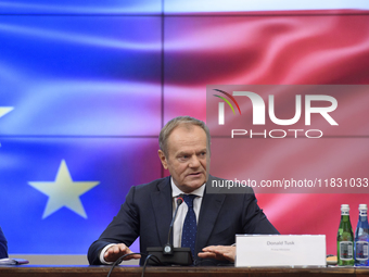 Polish Prime Minister Donald Tusk gestures as he speaks during a meeting with the Secretary-General of the Council of the European Union (EU...