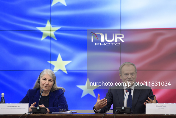 Polish Prime Minister Donald Tusk and Secretary-General of the Council of the European Union Therese Blanchet participate in a meeting with...