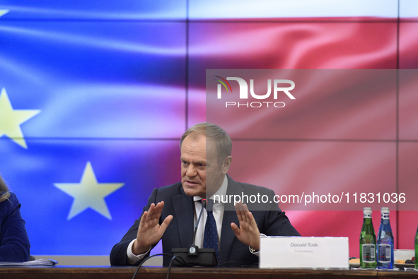 Polish Prime Minister Donald Tusk gestures as he speaks during a meeting with the Secretary-General of the Council of the European Union (EU...