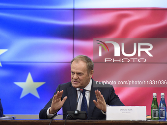 Polish Prime Minister Donald Tusk gestures as he speaks during a meeting with the Secretary-General of the Council of the European Union (EU...