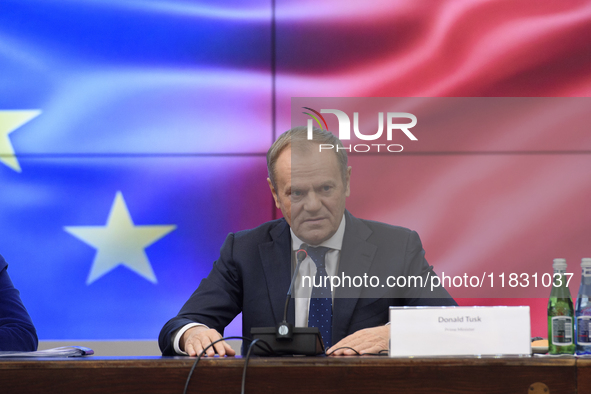 Polish Prime Minister Donald Tusk gestures as he speaks during a meeting with the Secretary-General of the Council of the European Union (EU...