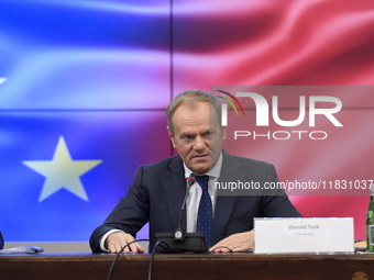 Polish Prime Minister Donald Tusk gestures as he speaks during a meeting with the Secretary-General of the Council of the European Union (EU...