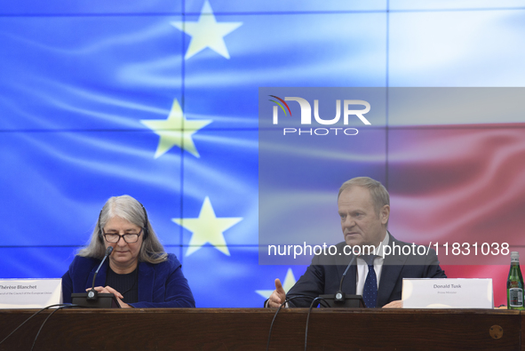 Polish Prime Minister Donald Tusk and Secretary-General of the Council of the European Union Therese Blanchet participate in a meeting with...