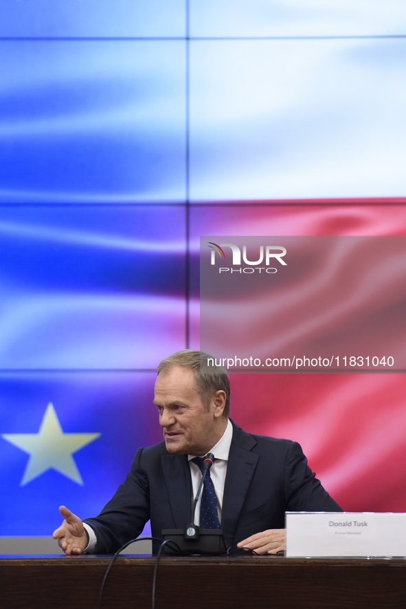 Polish Prime Minister Donald Tusk gestures as he speaks during a meeting with the Secretary-General of the Council of the European Union (EU...