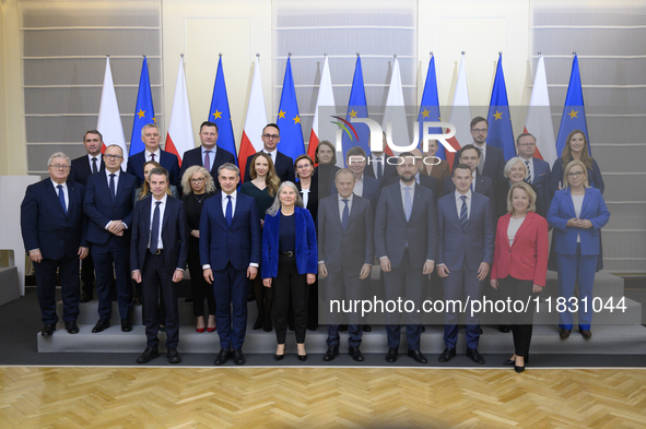 Polish Prime Minister Donald Tusk and the Polish Ministerial Cabinet pose for a family photo with Secretary-General of the Council of the Eu...