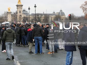 Taxi drivers gather at the Invalides during a protest against lower mileage rates for medical patient transport in Paris, France, on Decembe...