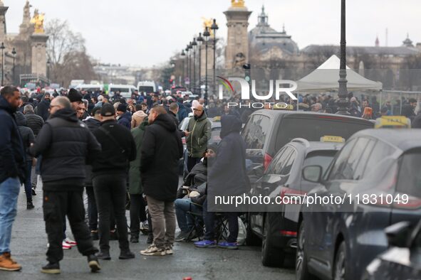 Taxi drivers gather at the Invalides during a protest against lower mileage rates for medical patient transport in Paris, France, on Decembe...